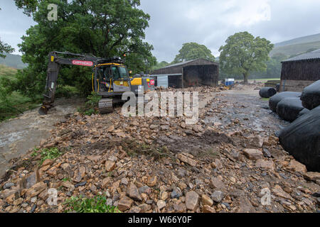 Arkengarthdale, North Yorkshire, UK. 31st July 2019.Douglas Barninghams farm in Arkengarthdale was left a scene of devastation after the flash flood which ripped through Swaledale yesterday. Over 300 bales of silage were swept away and around 200 sheep are still missing, also presumed to be swept away. Credit: Wayne HUTCHINSON/Alamy Live News Stock Photo