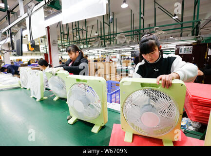 --FILE--Female Chinese workers produce components and parts of electric fans to be exported to the United States and Europe at a factory in Jiujiang c Stock Photo