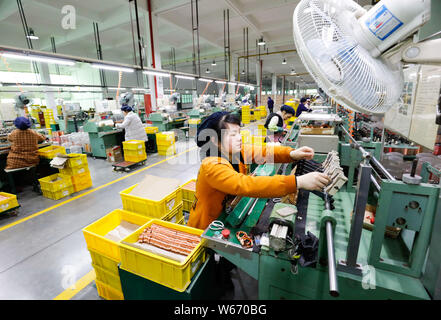 --FILE--Female Chinese workers produce components and parts of electric fans to be exported to the United States and Europe at a factory in Jiujiang c Stock Photo