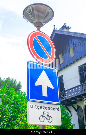 3 Dutch traffic signs in front of an old Dutch house Stock Photo