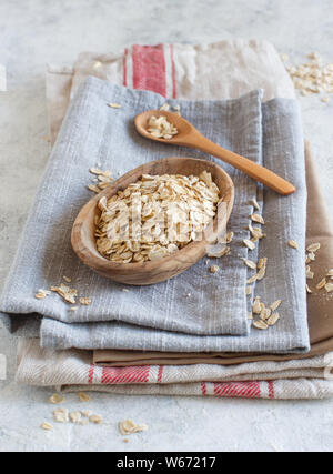 Rolled oats in a bowl on napkins background Stock Photo