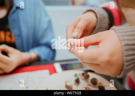 --FILE--A Chinese DIY enthusiast Xiaobei teaches a customer to create an artwork at her workshop in Beijing, China, 21 April 2018.   As machinery repl Stock Photo