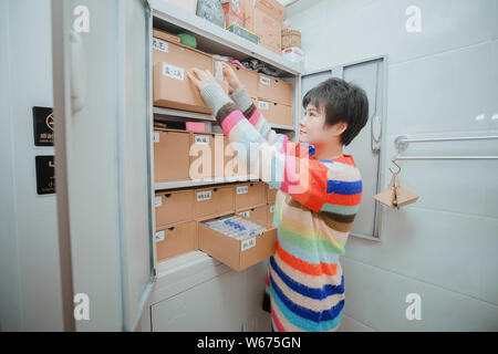 --FILE--A Chinese DIY enthusiast Xiaobei sorts out tools and materials used to create artworks at her workshop in Beijing, China, 21 April 2018.   As Stock Photo
