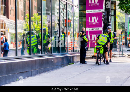 Police officer in downtown Montreal on bike Stock Photo