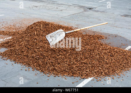 Shovel lying on top of a pile of wood chips Stock Photo