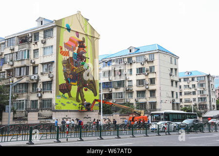View of the wall painting 'Troubadours' created by Spanish artist Dulk with the theme on care of children and animals on a residential building on Don Stock Photo
