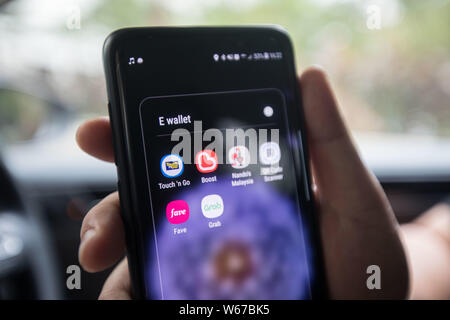 A customer shows icon of the mobile e-wallet payment service Touch&Go operated by TNG Digital Sdn Bhd, the joint-venture company between Touch 'n Go S Stock Photo