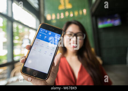 A customer shows the mobile e-wallet payment service Touch&Go operated by TNG Digital Sdn Bhd, the joint-venture company between Touch 'n Go Sdn Bhd ( Stock Photo