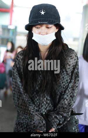 Chinese singer Cheng Xiao of South Korean-Chinese girl group Cosmic Girls, also known as WJSN, arrives at the Beijing Capital International Airport in Stock Photo