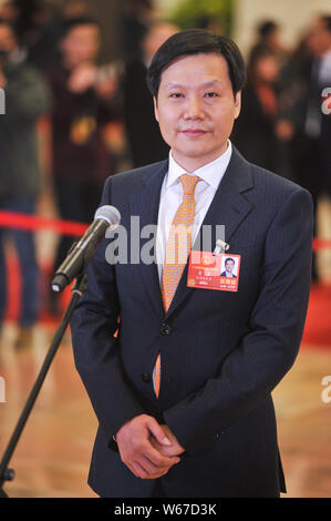 --FILE--Lei Jun, Chairman and CEO of Xiaomi Technology and Chairman of Kingsoft Corp., is interviewed as he arrives at the 'deputy passage' during the Stock Photo