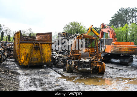 Piles of burnt cars are pictrured at a scrap yard in Ammanford, Wales, UK after a fire, leaving twisted and chard metal everywhere. Stock Photo