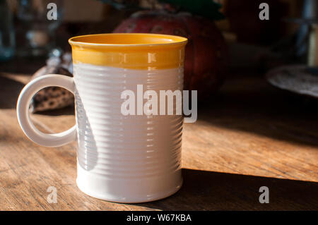 Ceramic tea mug closeup on wooden board surface Stock Photo