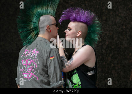 Two punks with Mohican haircut & liberty spikes in Blackpool, Lancashire, UK. 31st July, 2019.  Rebellion Festival world's largest punk festival in Blackpool. At the beginning of August, Blackpool’s Winter Gardens plays host to a massive line up of punk bands for the 21st edition of Rebellion Festival attracting thousands of tourists to the resort.  Over 4 days every August in Blackpool, the very best in Punk gather for this social event of the year with 4 days of music across 6 stages with masses of bands. Credit; MediaWorldImages/Alamy Live News Stock Photo