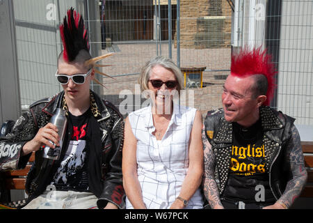Blackpool, Lancashire, UK. 31st July, 2019.  Victoria with two punk rockers at the Rebellion Festival world's largest punk festival in Blackpool.  At the beginning of August, Blackpool’s Winter Gardens plays host to a massive line up of punk bands for the 21st edition of Rebellion Festival attracting thousands of tourists to the resort.  Over 4 days every August in Blackpool, the very best in Punk gather for this social event of the year with 4 days of music across 6 stages with masses of bands. Credit; MediaWorldImages/Alamy Live News Stock Photo