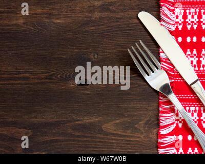 Fork and knife on kitchen towel and old wooden table Stock Photo