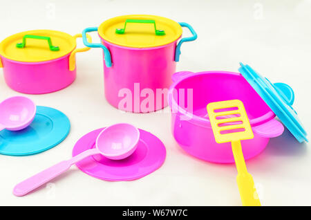 Set of children's toy colorful dishes isolated on white background. Kid toy utensil for girls game Stock Photo