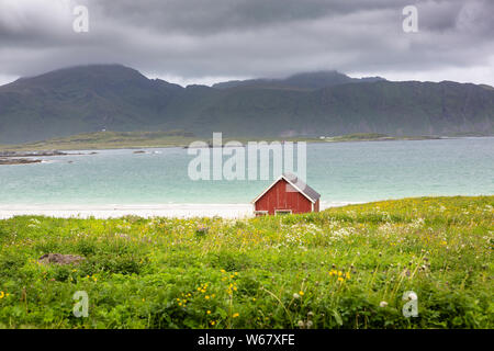 Fishing shack at the beach of Ramberg on the island Flakstadøya, Lofoten islands, Norway Stock Photo