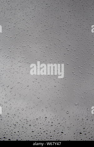 Raindrops on window-pane blurred background Stock Photo