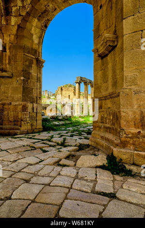 The ruins of Jerash, wihich is the site of the ruins of the Greco-Roman city of Gerasa, as seen through the North Tetrapylon along the North Decumanus Stock Photo
