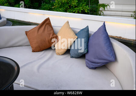 Pillows on mattress sofa in balcony and pool at restaurant Stock Photo