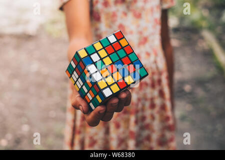 NORALA, PH – JUN 16, 2019: Rubik's Cube was invented in 1974 by Hungarian sculptor and professor of architecture Erno Rubik. Girl holding the puzzle. Stock Photo