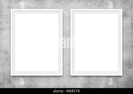 two blank picture frames hanging on concrete wall, mock-up Stock Photo
