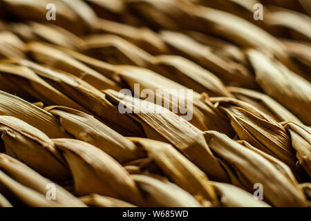 Macro closeup on weave of natural straw table mat round braided Stock Photo
