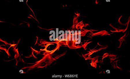 Fire flames on Abstract art black background, Burning red hot sparks rise from large fire in, Fiery orange glowing Stock Photo