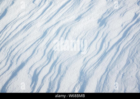 Abstract natural snow background texture; snowdrift relief with nice curved shadows Stock Photo
