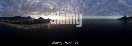Sunrise 360 degree full panoramic aerial view of Rio de Janeiro with Ipanema beach in the foreground and the wider cityscape in the background with cl