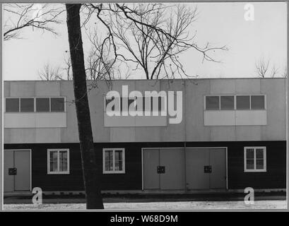 Sutter County, near Yuba City, California. Detail of front view of multiple family dwellings in Yub . . .; Scope and content:  Full caption reads as follows: Sutter County, near Yuba City, California. Detail of front view of multiple family dwellings in Yuba City farm workers community, (F.S.A.) Each unit to house six families, each family occupies two stories, for hot weather, bedrooms on second floor ventilation by flaps which provide through ventilation and wall construction of a sheet material which is finished surface and insulation. Construction just completed. Stock Photo