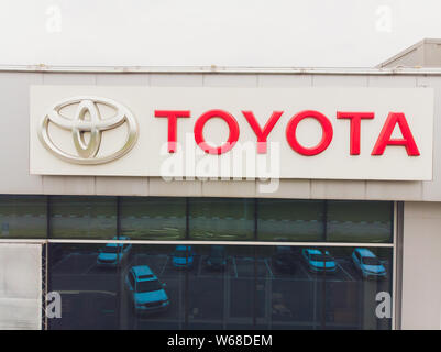 UFA, RUSSIA - August 25, 2018: Toyota dealership sign against blue sky. Toyota is the world's market leader in sales of hybrid electric vehicles. Stock Photo