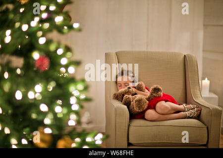 Young girl taking a nap with her teddy bear. Stock Photo