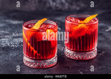 Negroni cocktail with orange peel and ice, selective focus. Stock Photo