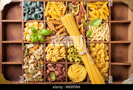 Assorted colorful italian pasta in wooden box Stock Photo