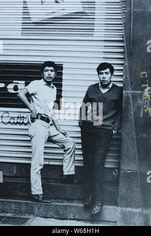 Fine black and white art photography from the 1970s of two Mexican men hanging out on the street. Stock Photo