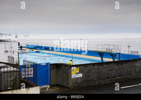 Gourock, Inverclyde / Scotland, UK - July 27th 2019: Outdoor open air swimming pool starts lessons for senior elderly and disabled swimmers