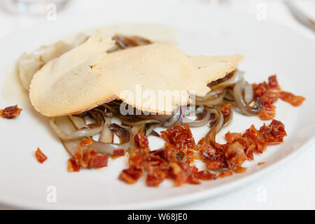 Cooked radiccio salad with bacon, close-up Stock Photo