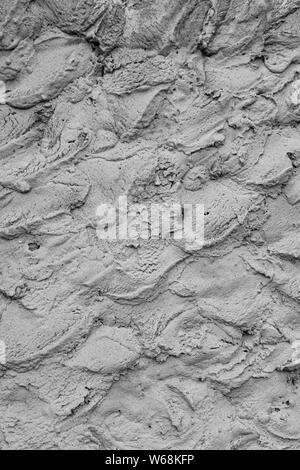 Rough cement plaster on the wall. Facade plaster background. Single-ply monolithic plaster decorative background. Single layer scraped cement plaster Stock Photo
