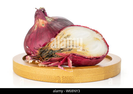 Group of one whole one half of stale red onion on bamboo plate isolated on white background Stock Photo