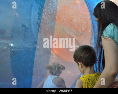 Kids having fun in inflatable bubble balls on water in amusement park,Svilajnac, Serbia, Europe Stock Photo