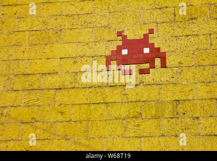 Pixel art of an alien on a yellow brick wall Stock Photo