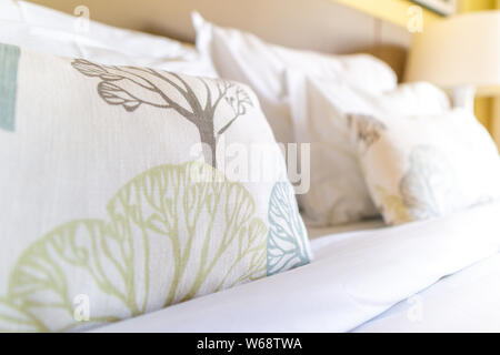Image of several pillows on bed with white blanket, decoration Stock Photo