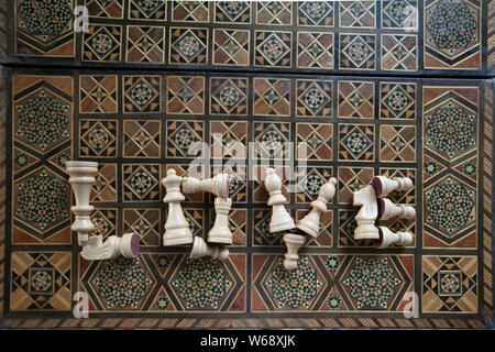 Top view of a word Love from chess pieces on an inlaid chessboard, selective focus Stock Photo