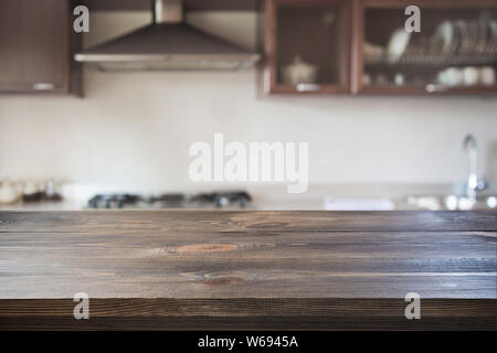 Blurred modern kitchen with wooden tabletop for display product. Abstract background. Stock Photo