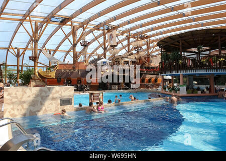 Liptovsky Mikulas, Slovakia - May 04, 2014: Blue big swimming pool and a pirate ship in the aquapark in Liptovsky Mikulas, Slovakia. Stock Photo