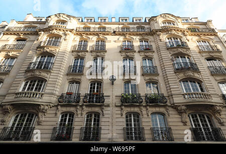 Traditional French house with typical balconies and windows. Paris, France. Stock Photo