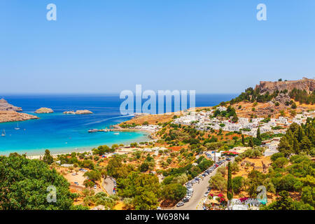 Sea skyview landscape photo Lindos bay and castle on Rhodes island, Dodecanese, Greece. Panorama with ancient castle and clear blue water. Famous tour Stock Photo