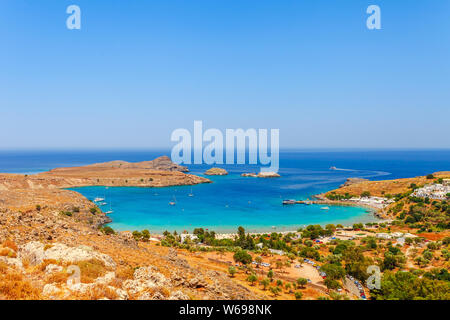 Sea skyview landscape photo Lindos bay and castle on Rhodes island, Dodecanese, Greece. Panorama with ancient castle and clear blue water. Famous tour Stock Photo
