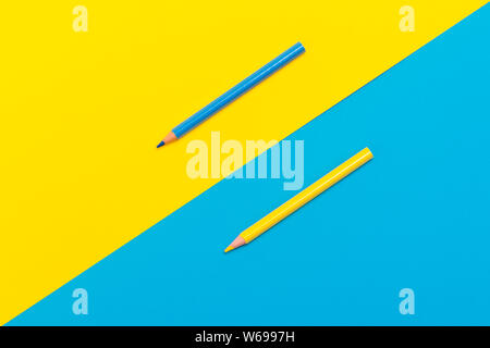 Back to scool - Pencils detail. Colored sharp pencils detail in a row, isolated on blue and yellow Stock Photo